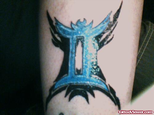 Blue Ink Gemini Tattoo On Bicep