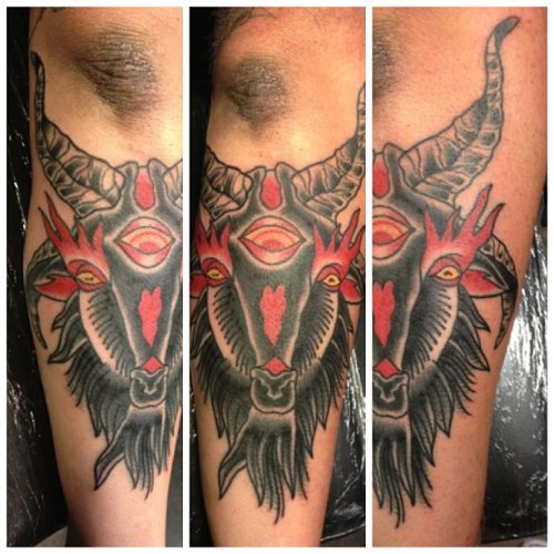 Red And Black Ink Goat Head Tattoo On Arm