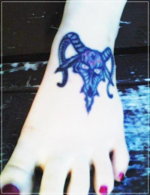 Blue Ink Goat Head Tattoo On Girl Left Foot