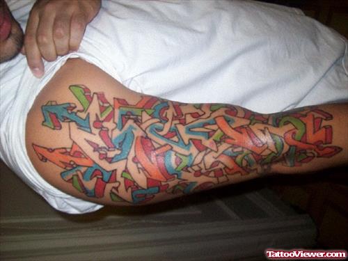 Man Showing His Graffiti Tattoo On Sleeve