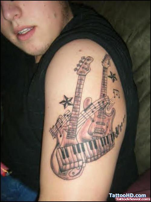 Grey Ink Guitar And Piano Graffiti Tattoo On Left Half Sleeve