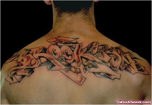 Awesome Grey Ink Graffiti Tattoo On Man Upperback