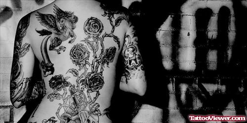 Rose Flowers And Graffiti Tattoo On Back