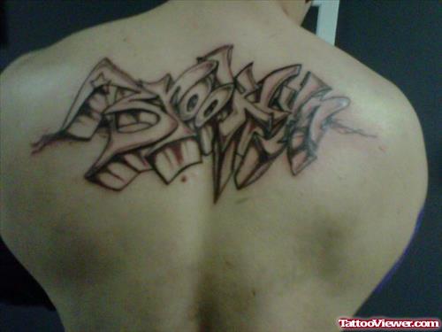 Crazy Grey Ink Graffiti Tattoo On Man Upperback