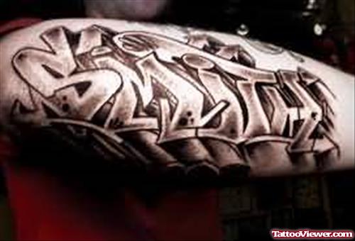 Grey Ink Graffiti Tattoo On Sleeve