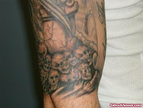 Grey Ink Skulls And Graveyard Tattoo On Half Sleeve