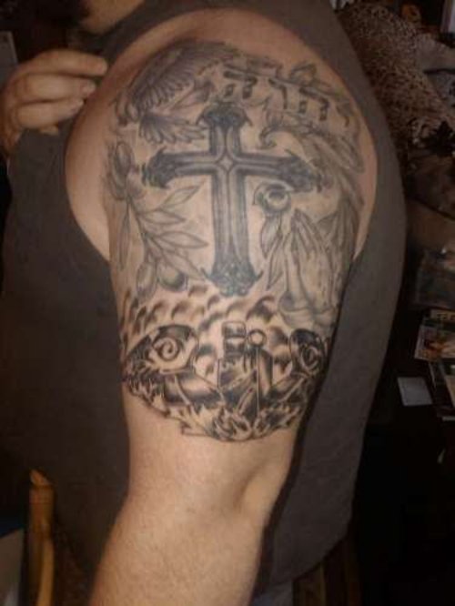 Grey Ink cross And Graveyard Tattoo On Left Half Sleeve