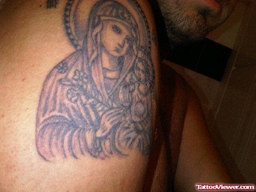 Grey Ink Greek Religious Tattoo