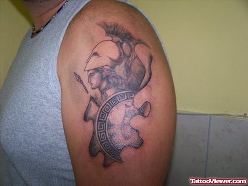 Grey Ink Greek Tattoo On Man Left Shoulder