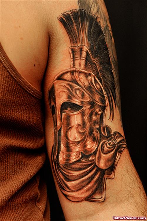 Grey Ink Spartan Mask Greek Tattoo On Biceps