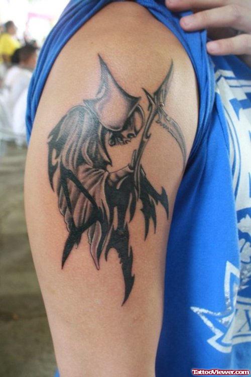 Black And Grey Ink Tribal Grim Reaper Tattoo On Biceps