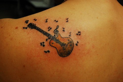 Amazing Music Notes And Guitar Tattoo On Back