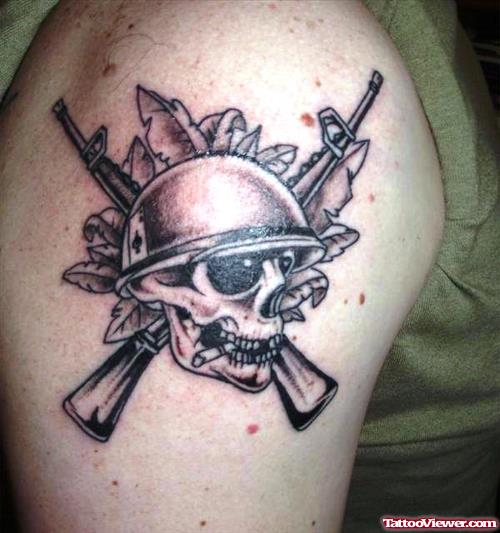 Grey Ink Skull And Gun Tattoos On Shoulder