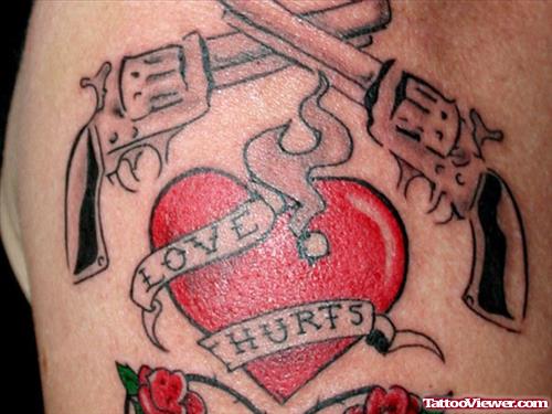 Flaming Red Heart And Guns Tattoo On Shoulder