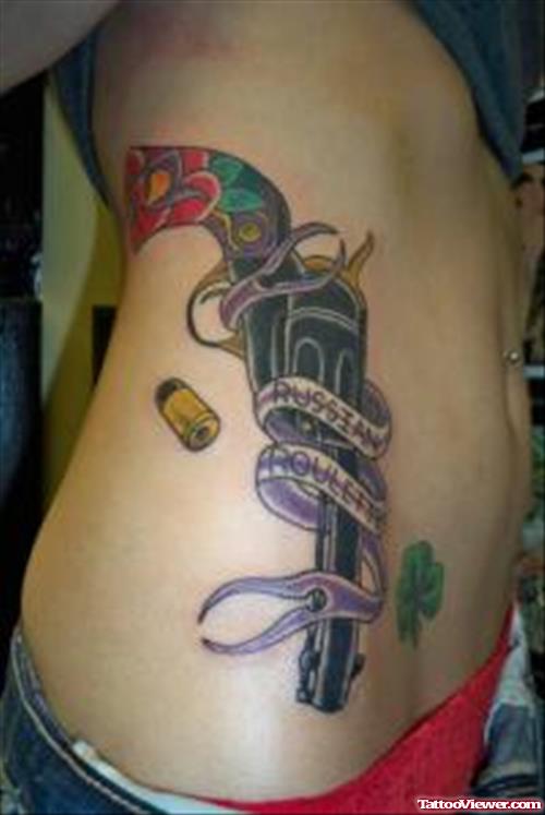 Colored Ink Gun With Banner Tattoo On Rib Side