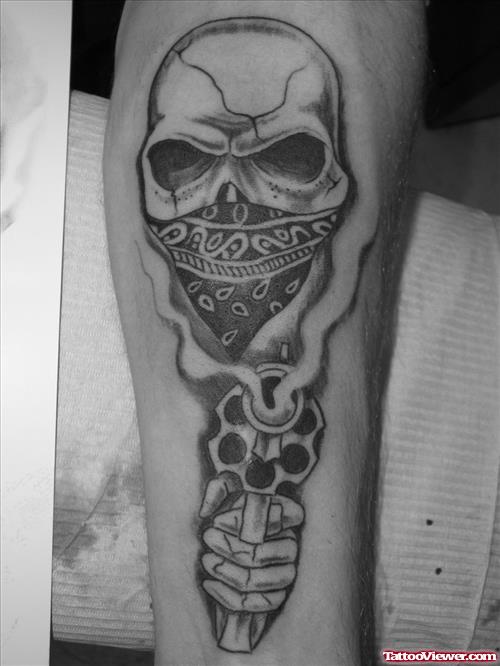 Skull With Gun Tattoo On Arm