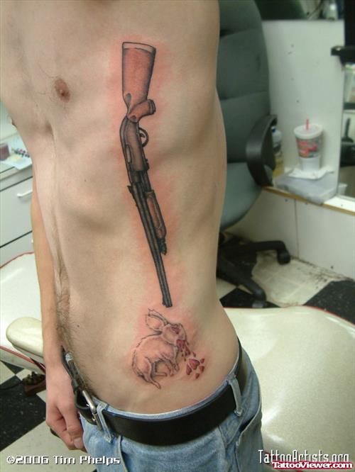 Gun shoot Rabbit Tattoo On Man Side Rib
