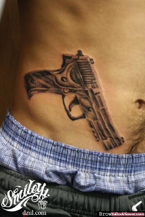Grey Ink Gun Tattoo On Hip