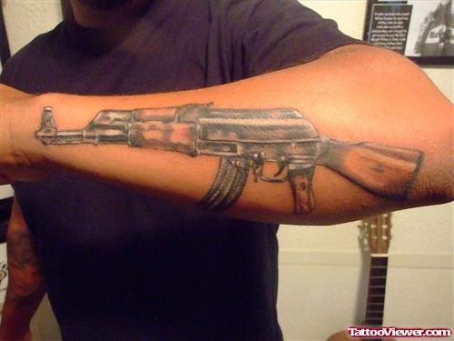 Color Ink Gun Tattoo On Man Left Sleeve