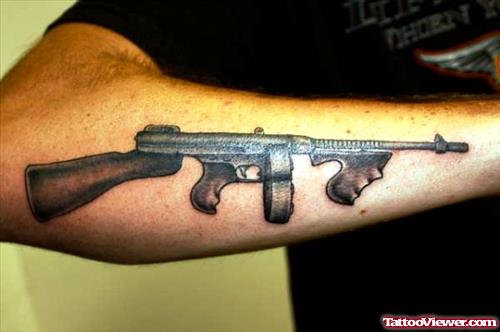 Grey Ink Gun Machine Tattoo On Right Arm