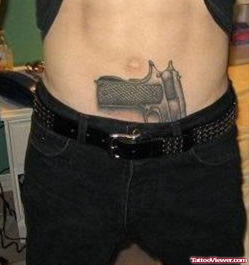 Dark Grey Ink Gun Tattoo On Belly