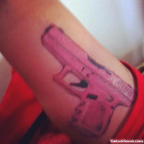 Color Ink Gun Tattoo On Bicep