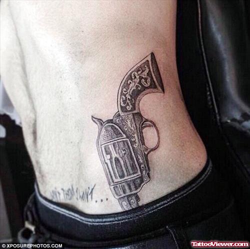Attractive Grey Ink Gun Tattoo On Hip