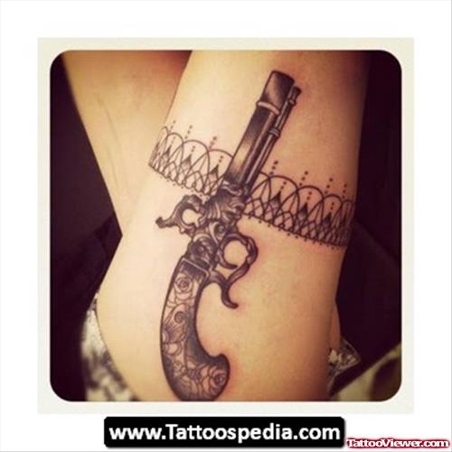Grey Ink Garter And Lace Gun Tattoo