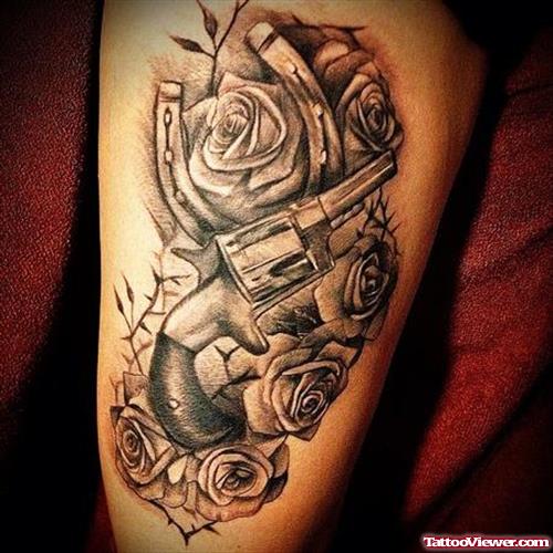 Grey Ink Rose Flowers And Gun Tattoo