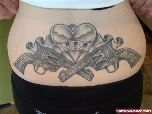 Grey Ink Heart And Guns Tattoos On Lowerback