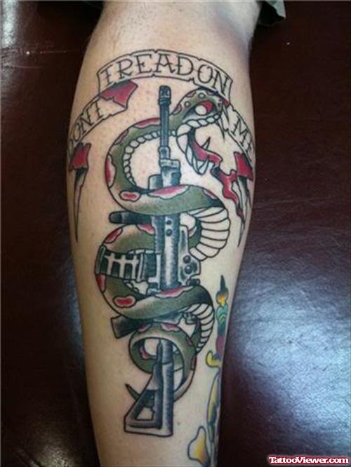 Green Ink Snake And Gun Tattoo On Leg