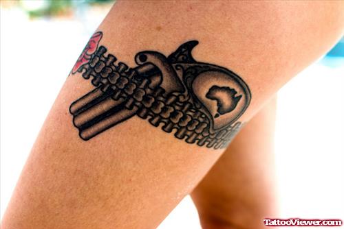Garter And Lace Gun Tattoo On Left Thigh