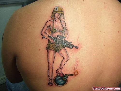 Pinup Girl With Gun Tattoo On Back Shoulder