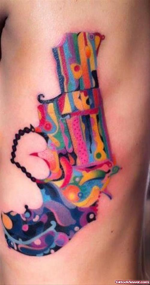 Colorful Gun Tattoo On Side Rib