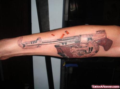 Brown Ink Gun Tattoo On Arm