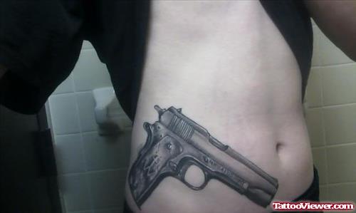 Grey Ink Gun Tattoo On Right Hip