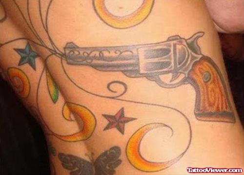 Colored Nautical Stars And Gun Tattoo On Back