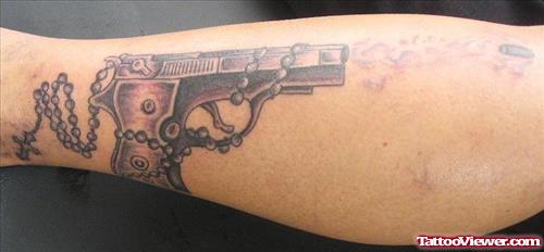 Rosary And Gun Tattoo On Leg