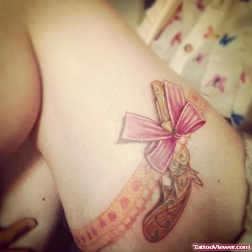 Ribbon and Gun Tattoo On Thigh