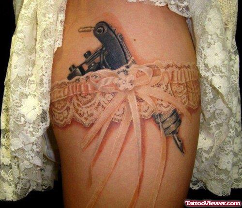 Garter And Lace And Gun Tattoo On Thigh