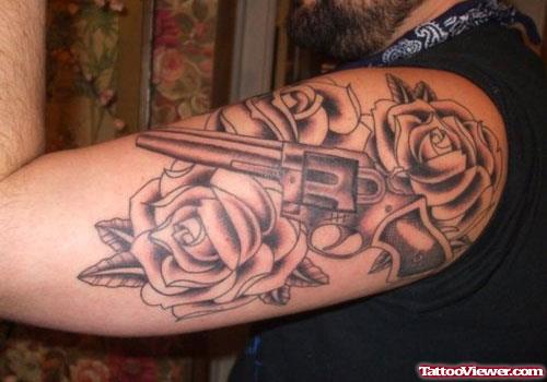 Grey Rose Flowers And Gun Tattoo On Half Sleeve
