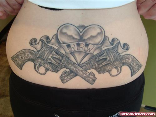Grey Ink Heart And Gun Tattoos On Lowerback