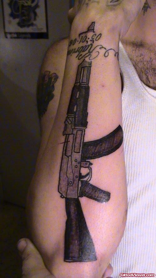 Black Ink Gun Tattoo On Right Arm