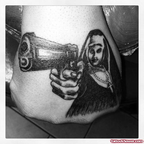 Black Ink Gun In Lady Hand Tattoo