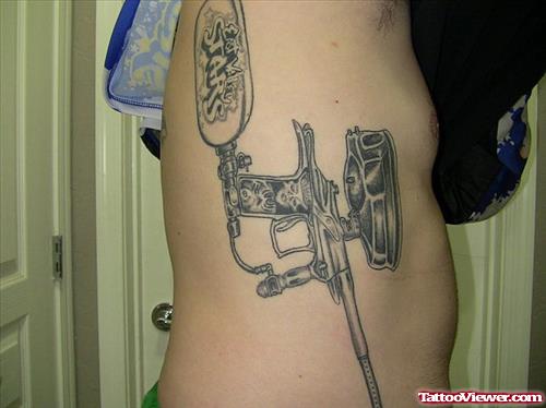 Rib side Grey Ink Gun Tattoo