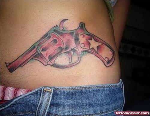 Red Ink Gun Tattoo On Hip