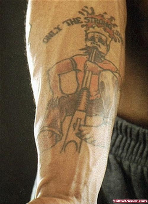 Marquis With Gun Tattoo On Right Arm