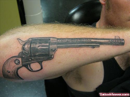 Large Gun Tattoo On Right Arm