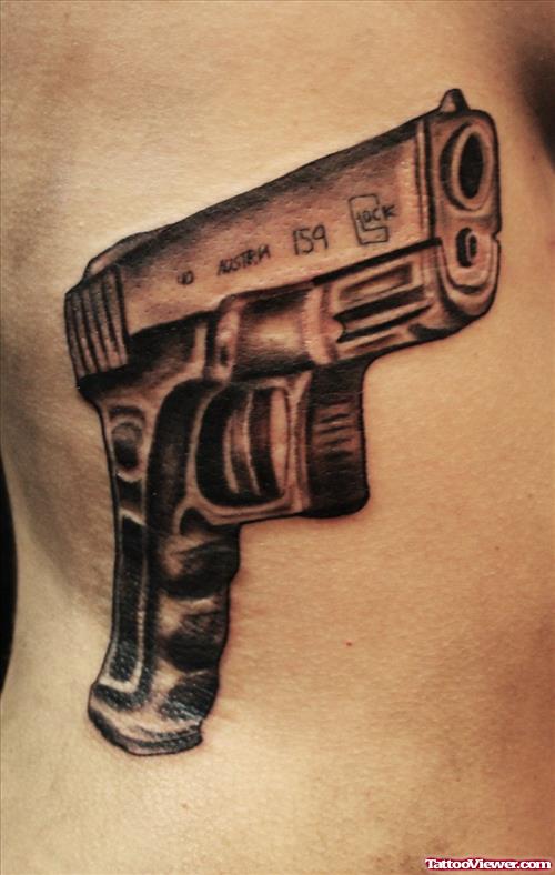Amazing Man Rib Side Gun Tattoo For Men