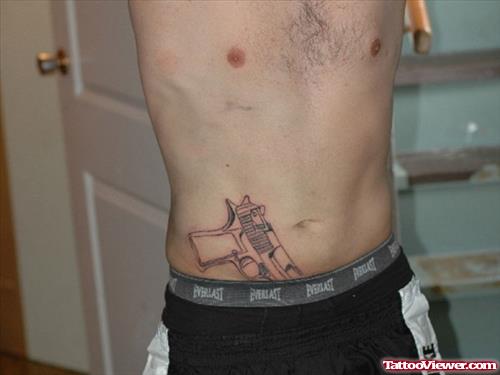 Pistol Tattoo On Man Side Rib